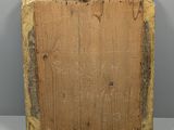 an image of a wooden plaque with two faces on it