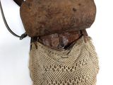 a bag with a wooden handle hanging on a wall