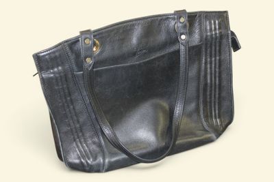 a black purse that is sitting on a table