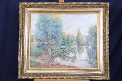 a painting on a easel with a painting of a river in the background