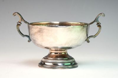 a silver bowl with handles on a white surface