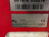 a label on the back of a red machine
