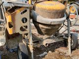 a cement mixer that is sitting on the ground