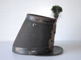 a black hat with a feather on top of it