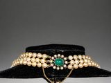 a black hat with pearls and a gold chain