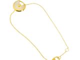a close up of a gold plated necklace with a heart pendant
