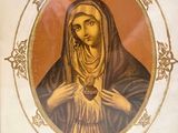 an image of a framed picture of a woman holding a rosary