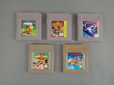 four nintendo game cartridges are lined up in a row on a table