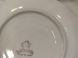 a white plate with a crown on it sitting on a table