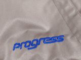 the back of a jacket with the word progress written on it