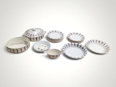 a lot of plates and bowls sitting on a table
