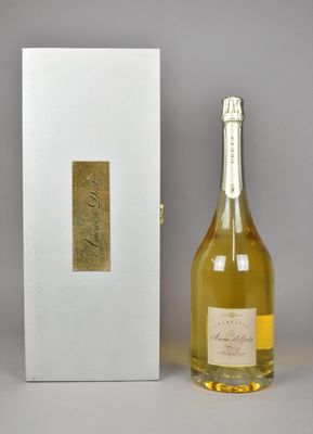 bottle of champagne in front of a white box with a gold label