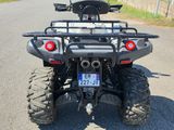 an image of a four wheeler atv parked on the side of the road