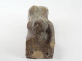 a small statue of a bear sitting on a white surface