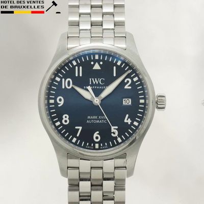 a close up of a wrist watch with a blue dial