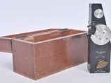 a small wooden box with a clock on top of it