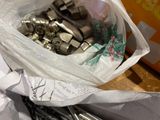 a bag full of screws and nuts on a table