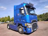 a blue semi truck parked in a parking lot