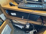 a computer desk with a keyboard and a monitor on it