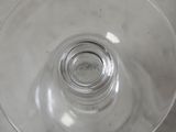 a glass with a liquid inside of it sitting on a table