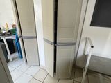a white refrigerator in the corner of a kitchen