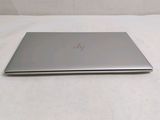 a laptop that is sitting on a white surface