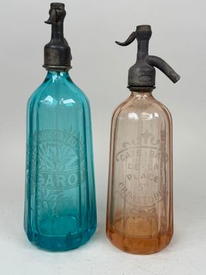 bottles with soap and lotion dispensers on a white surface