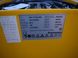 a close up of a yellow container with a sticker on it