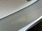 a close up of a car ' s front bumper with scratches on it