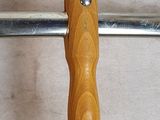 a close up of a wooden handle on a metal pole