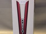 a box that has a red and white electric toothbrush in it