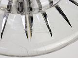 a lot of knives in a glass bowl on a table