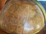 a wooden table with a large globe on top of it