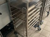 many trays of food sitting on the floor in the kitchen