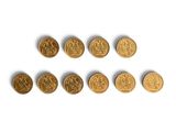 a group of six gold coins sitting on top of a white surface