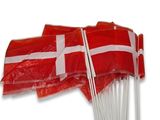 several red and white flags on sticks with a white cross on them