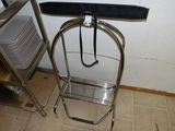 a metal stand with a black umbrella on top of it