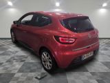 the rear end of a red car in a room with a checkered floor