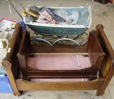 a baby ' s bed with a wooden frame and a baby ' s stroller