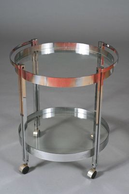 an image of a chrome and glass bar cart on wheels