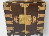a wooden chest with gold decorations on it