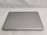 a silver laptop sitting on a white surface