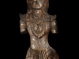 a close up of a statue on a black background with a black background