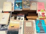 many books that are stacked on top of each other