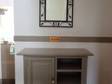 an image of a tv stand with a mirror above it
