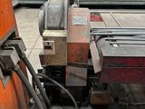 an image of a machine that is working on a piece of metal