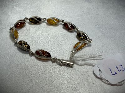 a close up of a bracelet on a table with a price tag