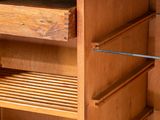 a wooden cabinet with drawers and shelves on it