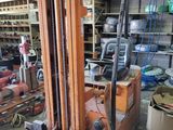 a forklift in a garage with a lot of tools