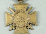 a gold medal with a ribbon around it on a table